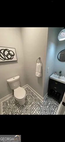 a bathroom with a sink a toilet and vanity
