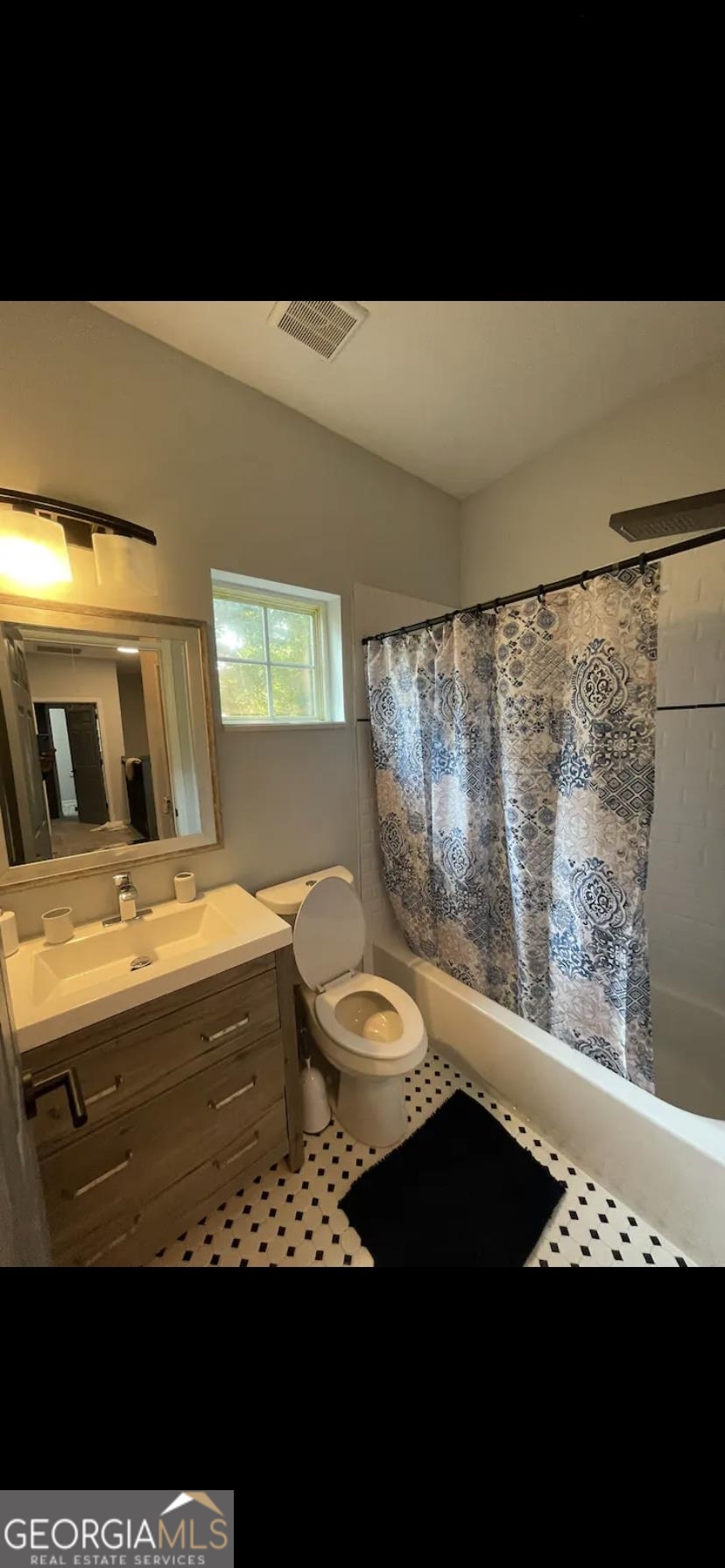 966 McDaniel Street Southwest Atlanta, GA 30310 - Photo 10 of 10 a bathroom with a granite countertop sink and a black white checkered floor
