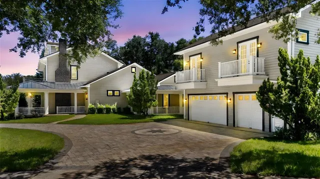 a front view of a house with a garden and plants