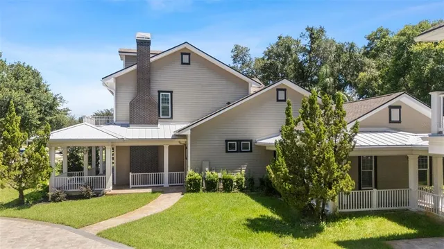 an aerial view of a house with a yard