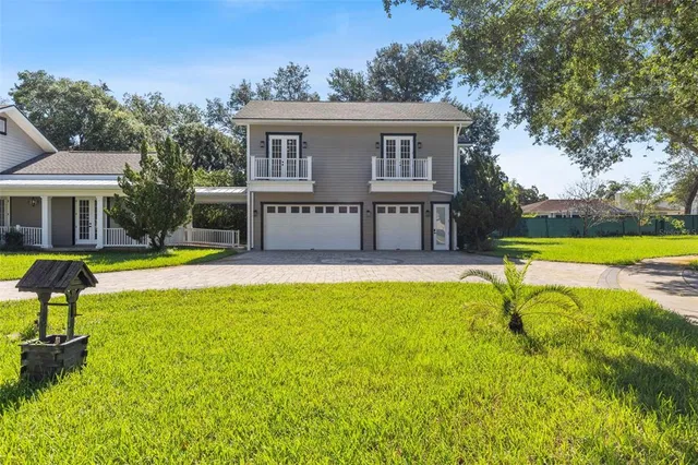 an aerial view of a houses with a lake view