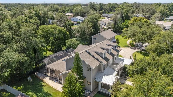 a large kitchen with stainless steel appliances kitchen island granite countertop a refrigerator and a sink