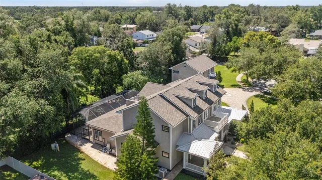 a large kitchen with stainless steel appliances kitchen island granite countertop a refrigerator and a sink