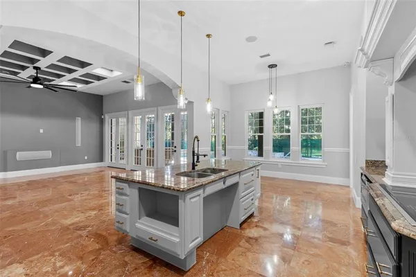 a kitchen that has a sink and a stove in it