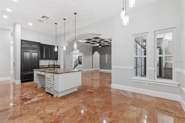 a view of a hallway with a chandelier and stairs
