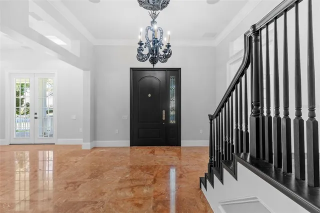 a view of a patio with a table and chairs under an umbrella