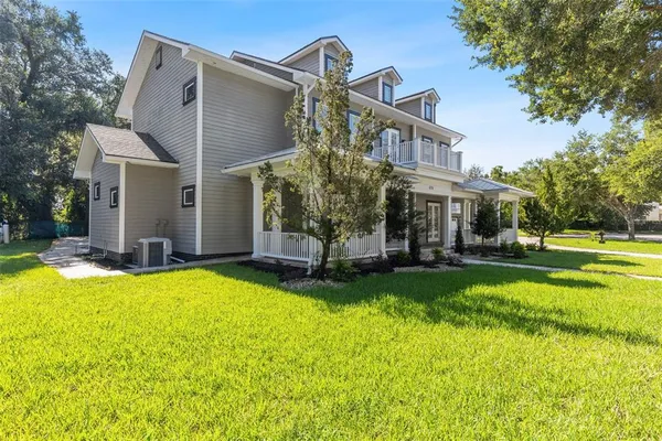 a view of a house with swimming pool and a yard