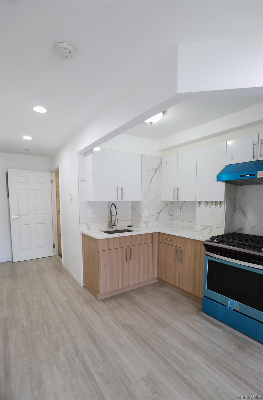 134-43 Maple Avenue, Unit 5B Queens, NY 11355 - Photo 5 of 13 a kitchen with a sink and a stove top oven