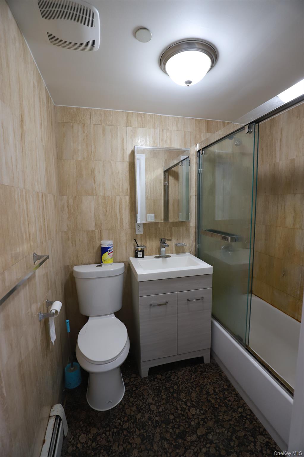134-43 Maple Avenue, Unit 5B Queens, NY 11355 - Photo 7 of 13 a bathroom with a toilet a sink and mirror