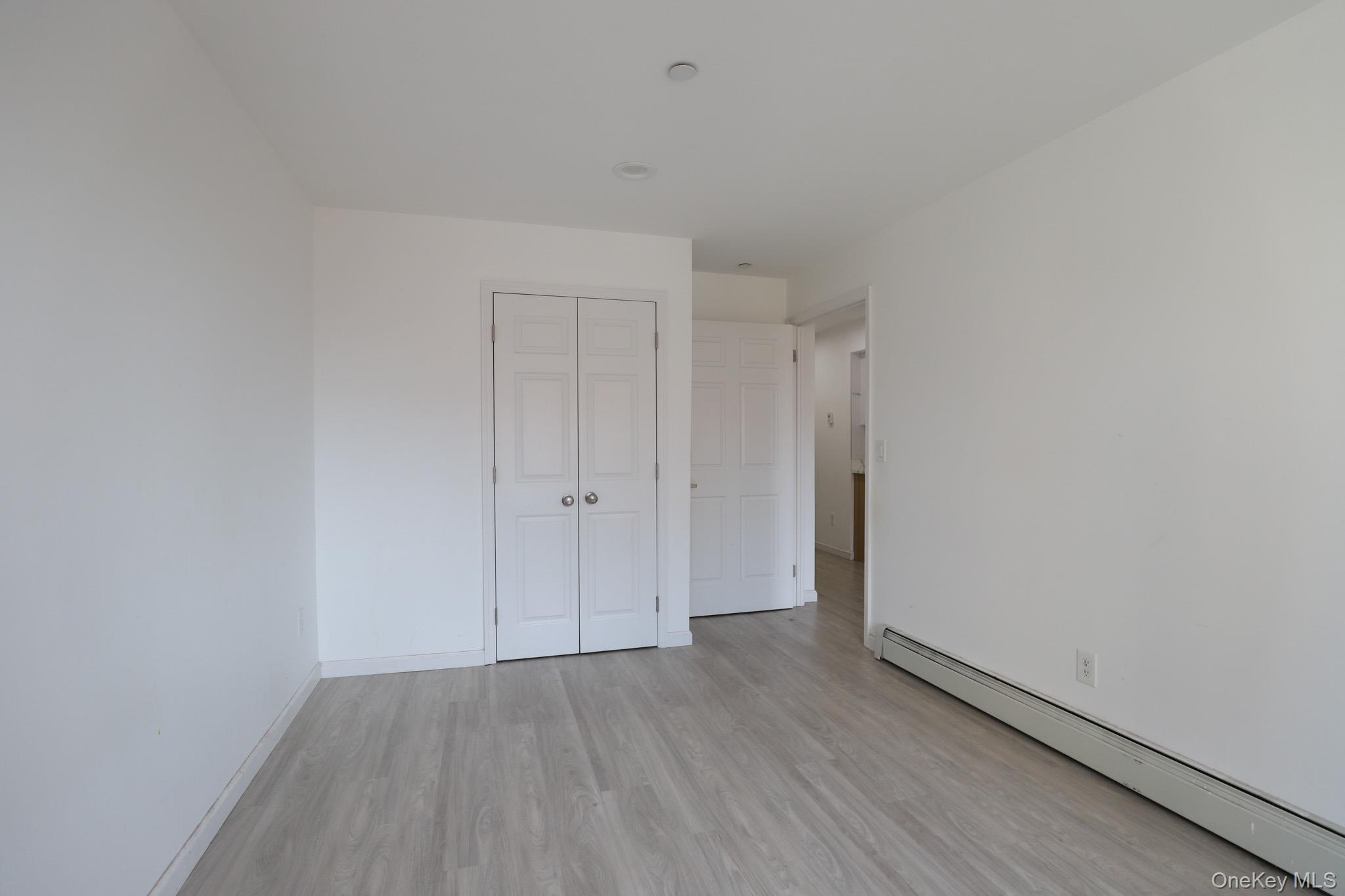 134-43 Maple Avenue, Unit 5B Queens, NY 11355 - Photo 9 of 13 a view of hallway with wooden floor