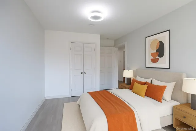 a bedroom with a bed and painting on the wall