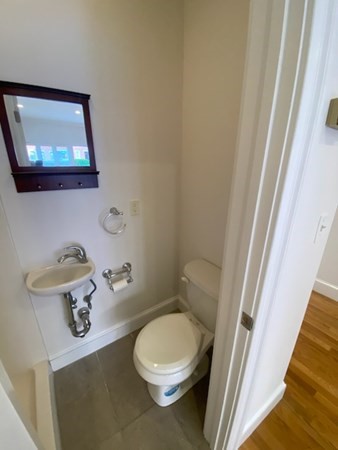 a white toilet sitting next to a small bathroom