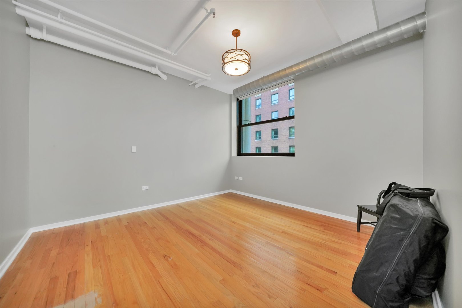 6 East Monroe Street, Unit 1501 Chicago, IL 60603 - Photo 15 of 27 a view of a room with wooden floor and fan