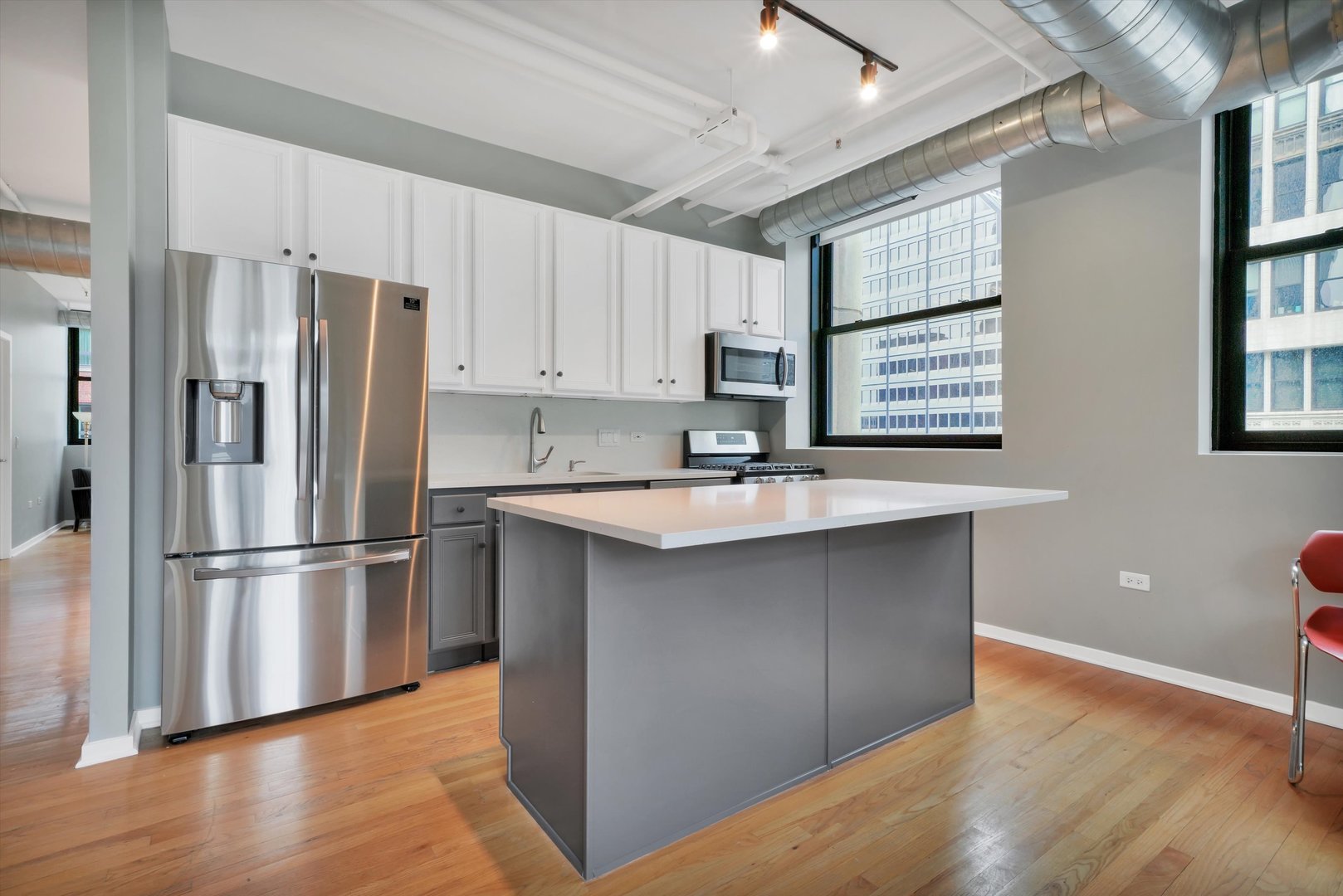 6 East Monroe Street, Unit 1501 Chicago, IL 60603 - Photo 2 of 27 a kitchen with stainless steel appliances granite countertop a refrigerator a sink and white cabinets