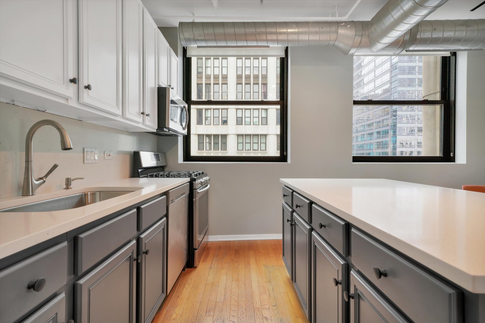 6 East Monroe Street, Unit 1501 Chicago, IL 60603 - Photo 4 of 27 a kitchen with a sink and a window