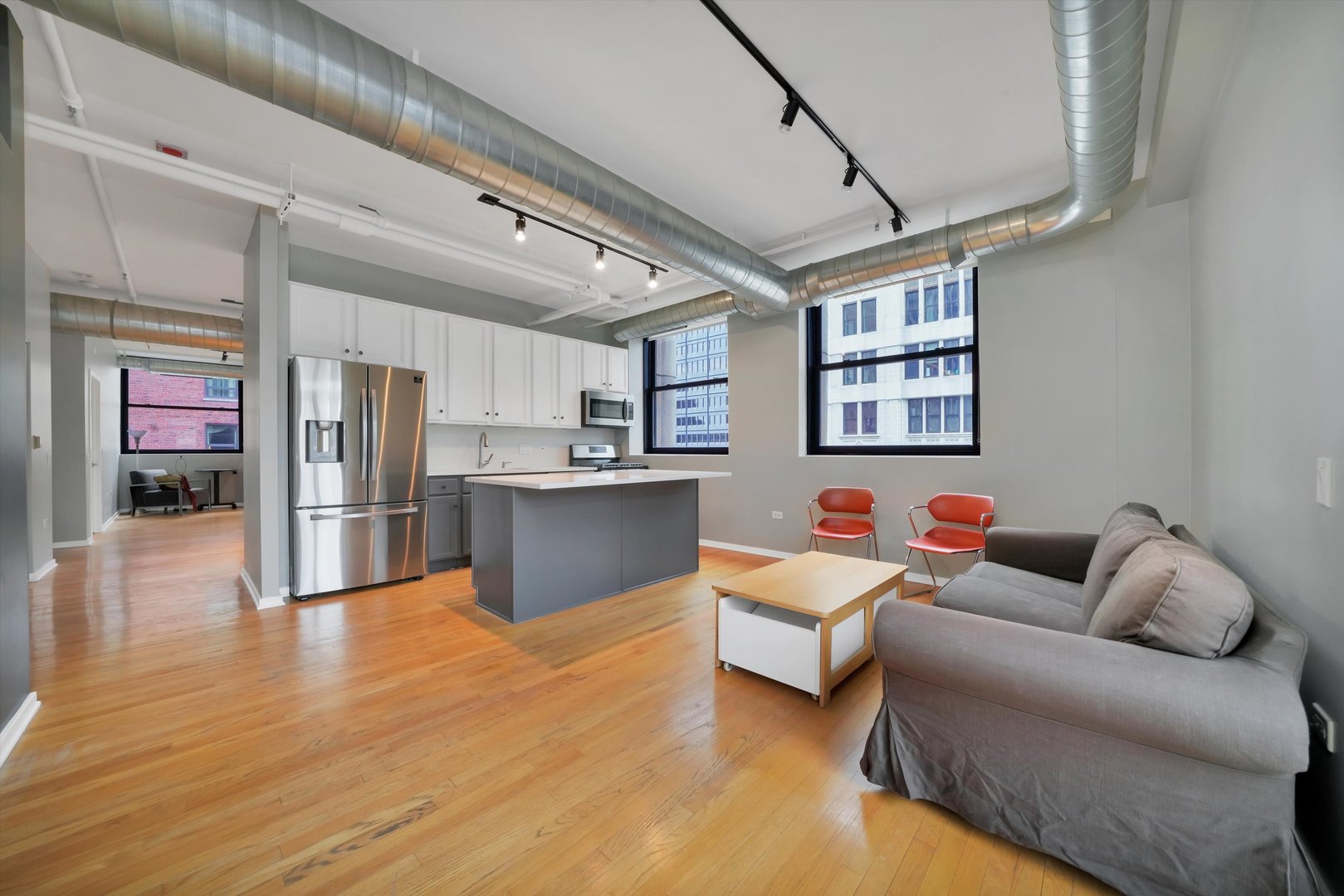 6 East Monroe Street, Unit 1501 Chicago, IL 60603 - Photo 5 of 27 a living room with furniture and kitchen view
