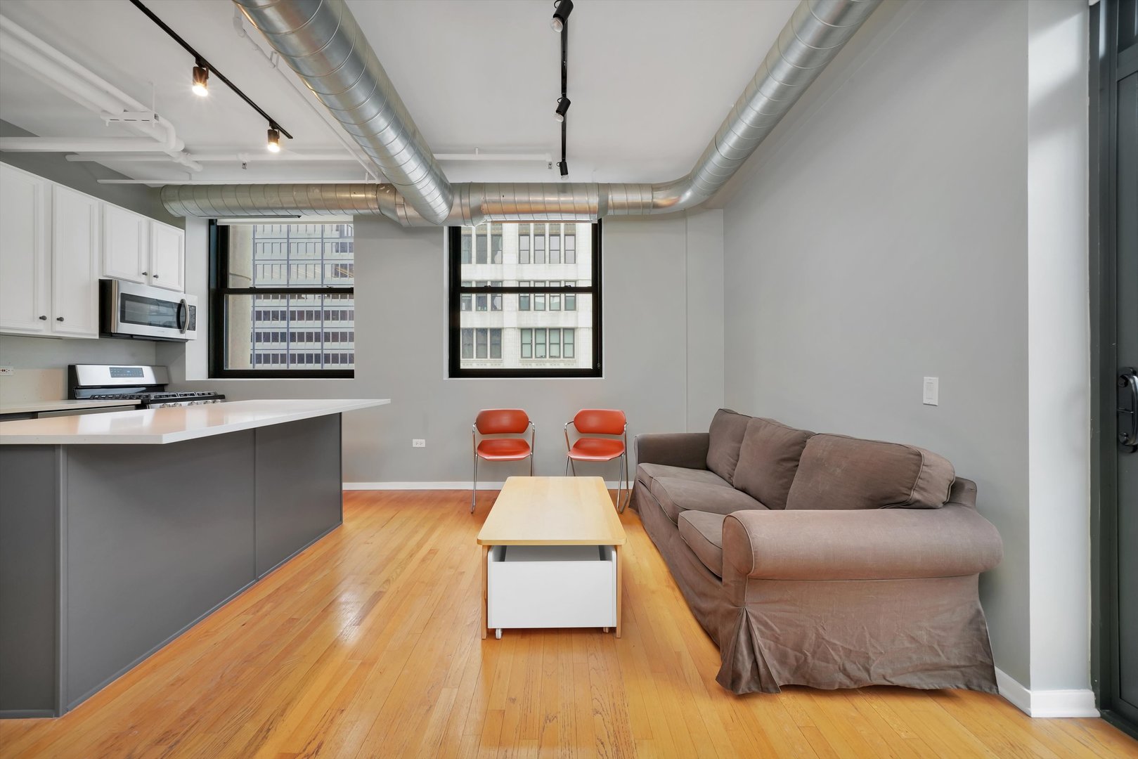 6 East Monroe Street, Unit 1501 Chicago, IL 60603 - Photo 6 of 27 a living room with furniture and windows