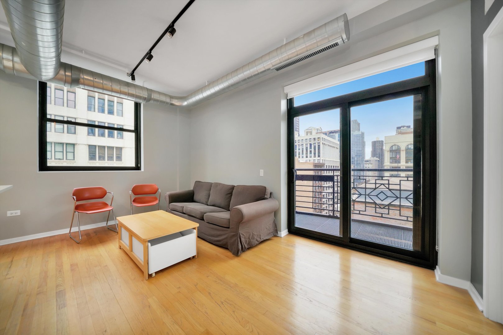 6 East Monroe Street, Unit 1501 Chicago, IL 60603 - Photo 7 of 27 a living room with couches and a large window with outer view
