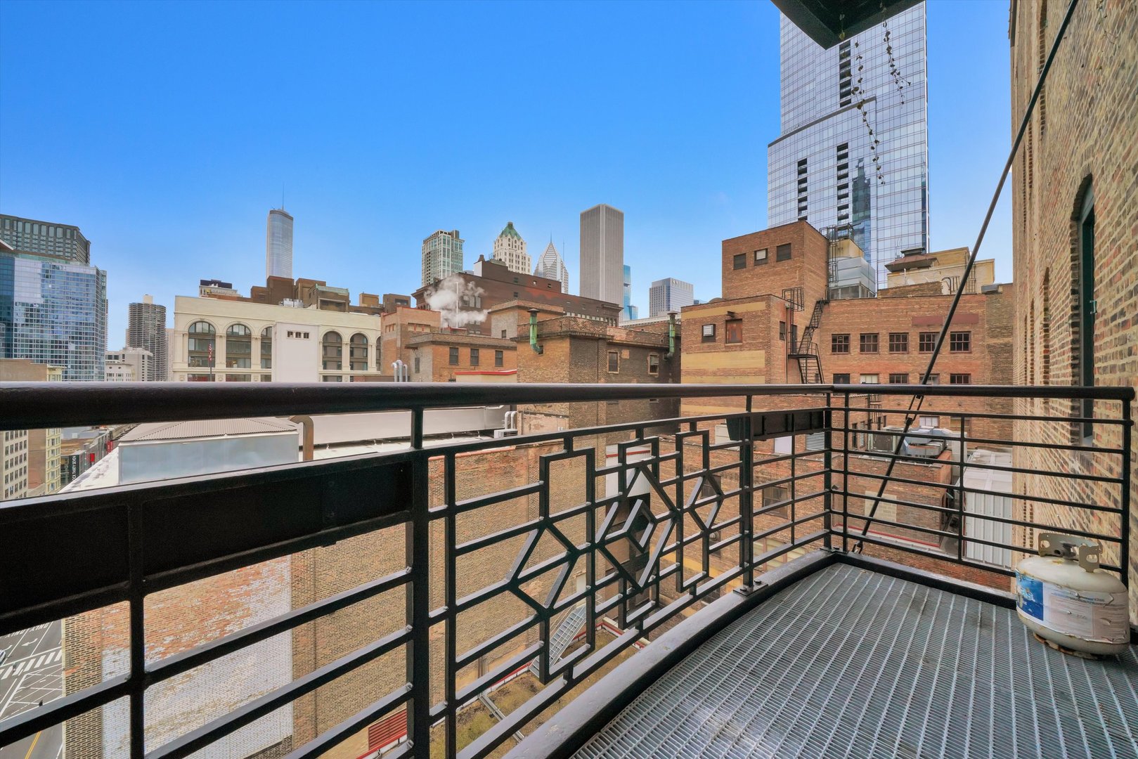 6 East Monroe Street, Unit 1501 Chicago, IL 60603 - Photo 9 of 27 a view of a balcony with wooden floor and fence