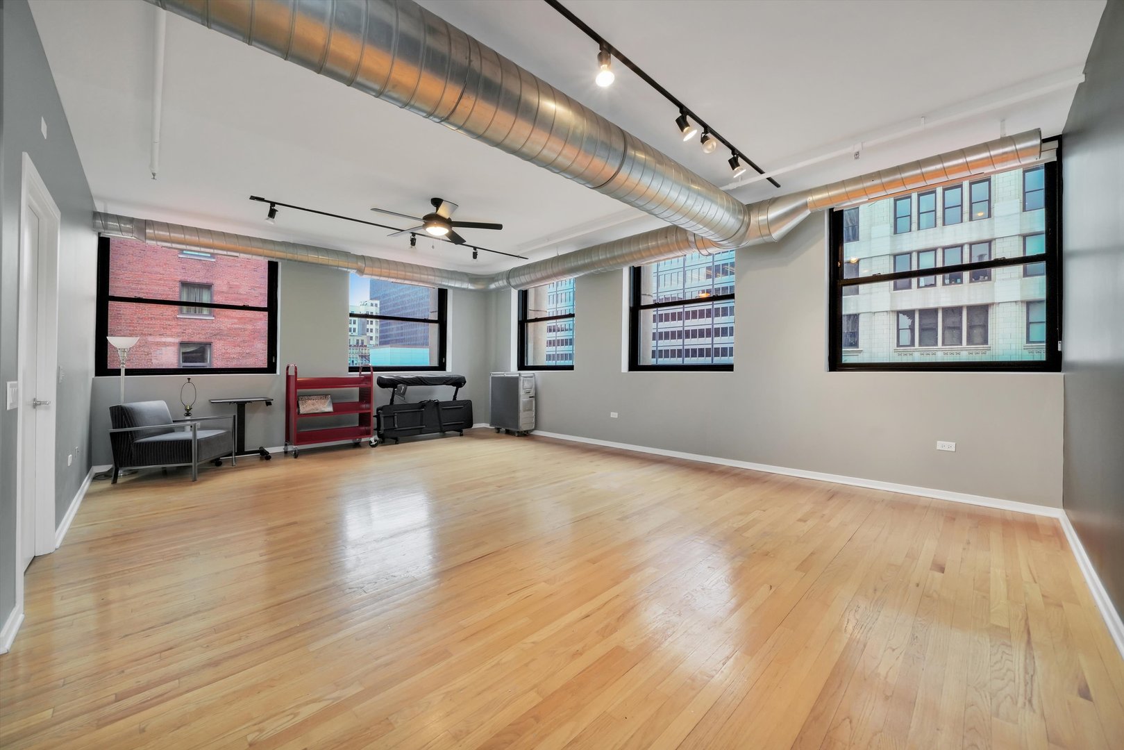 6 East Monroe Street, Unit 1501 Chicago, IL 60603 - Photo 10 of 27 a view of a livingroom with furniture a flat screen tv and windows