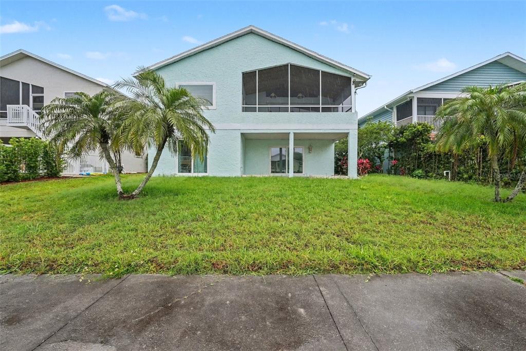 6225 Bayside Drive New Port Richey, FL 34652 - Photo 26 of 31 a front view of a house with a yard and potted plants