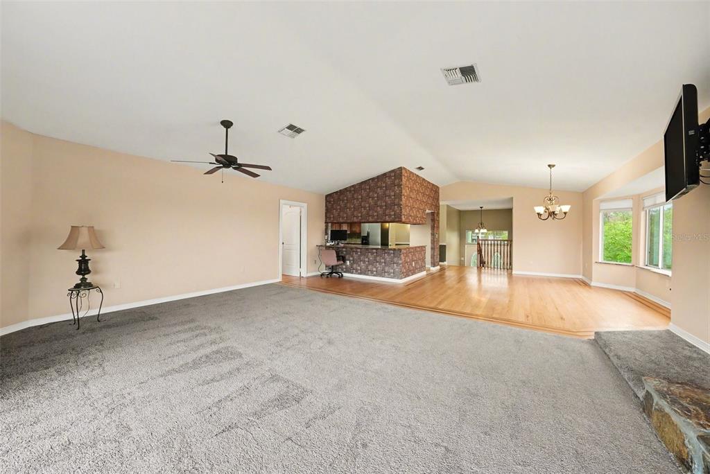 6225 Bayside Drive New Port Richey, FL 34652 - Photo 5 of 31 a view of a livingroom with a fireplace and a chandelier