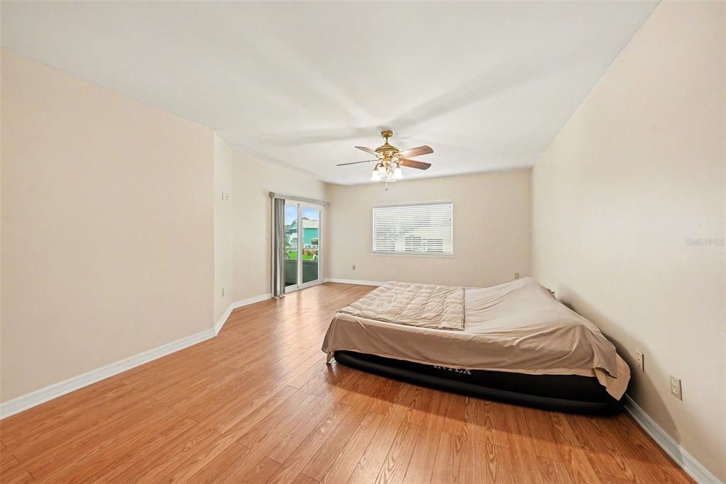 6225 Bayside Drive New Port Richey, FL 34652 - Photo 8 of 31 a bedroom with a bed and a window