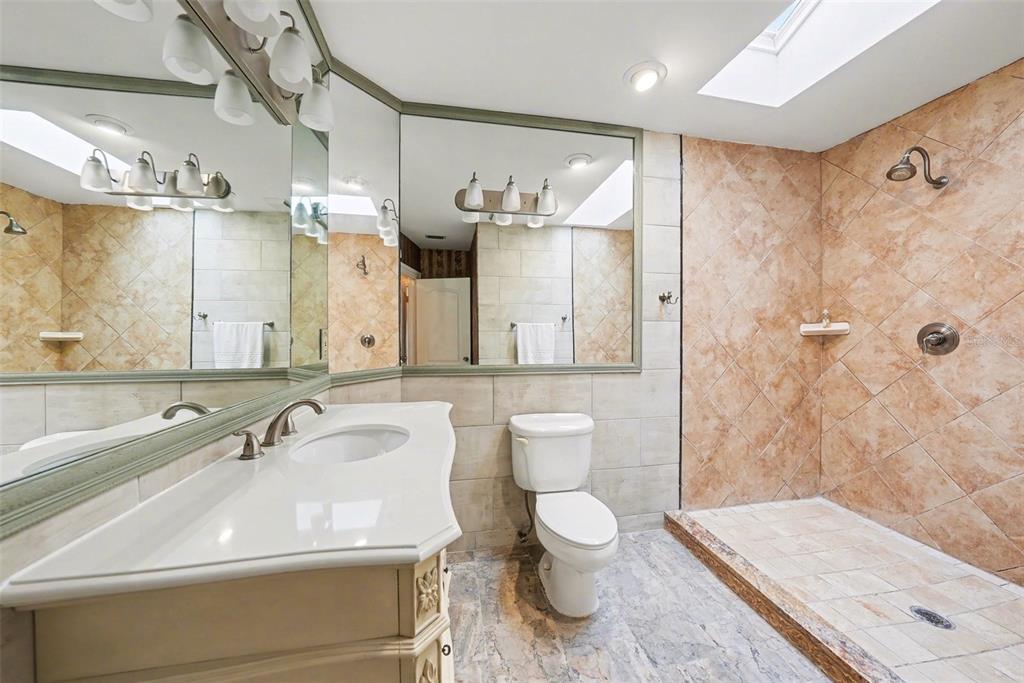 6225 Bayside Drive New Port Richey, FL 34652 - Photo 9 of 31 a bathroom with a sink a toilet and shower