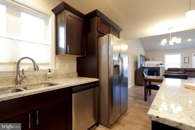 a kitchen with stainless steel appliances a sink and a refrigerator
