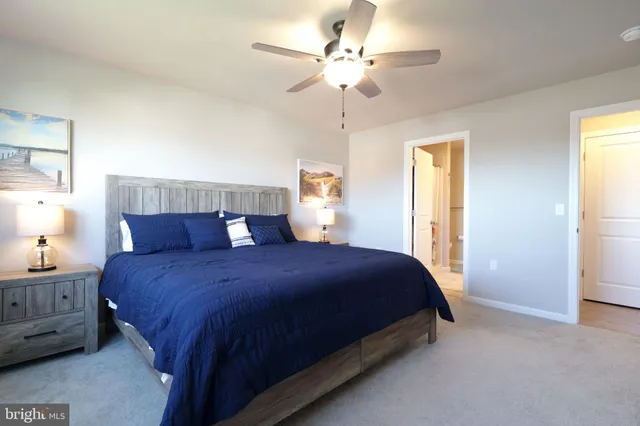a bedroom with a bed a chandelier and a window