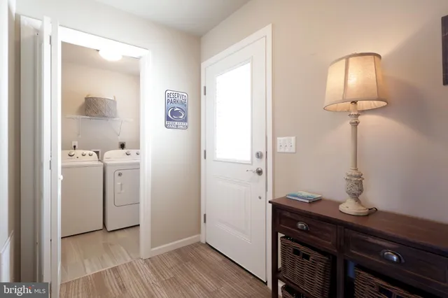 a view of bathroom with a sink mirror and wooden floor