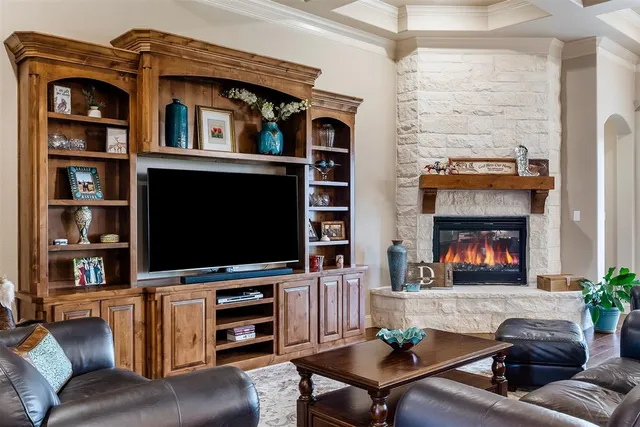 a living room with fireplace furniture and a flat screen tv