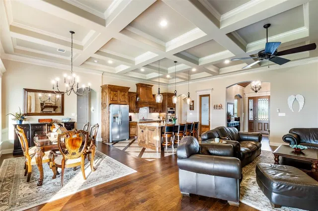 a living room with furniture and a chandelier