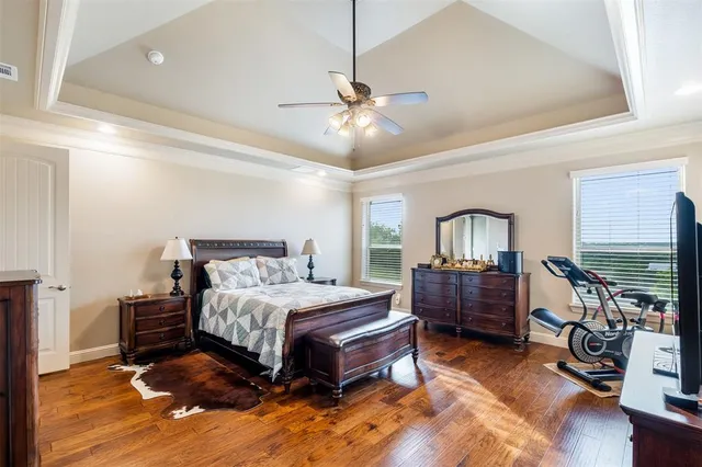 a bedroom with bed and a chandelier
