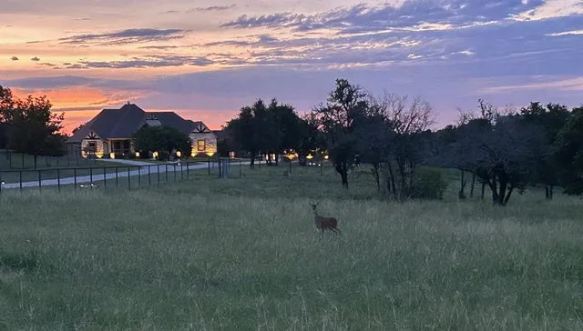 a view of a lake with sunset in background