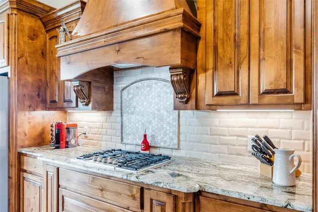 a kitchen with a stove and cabinets