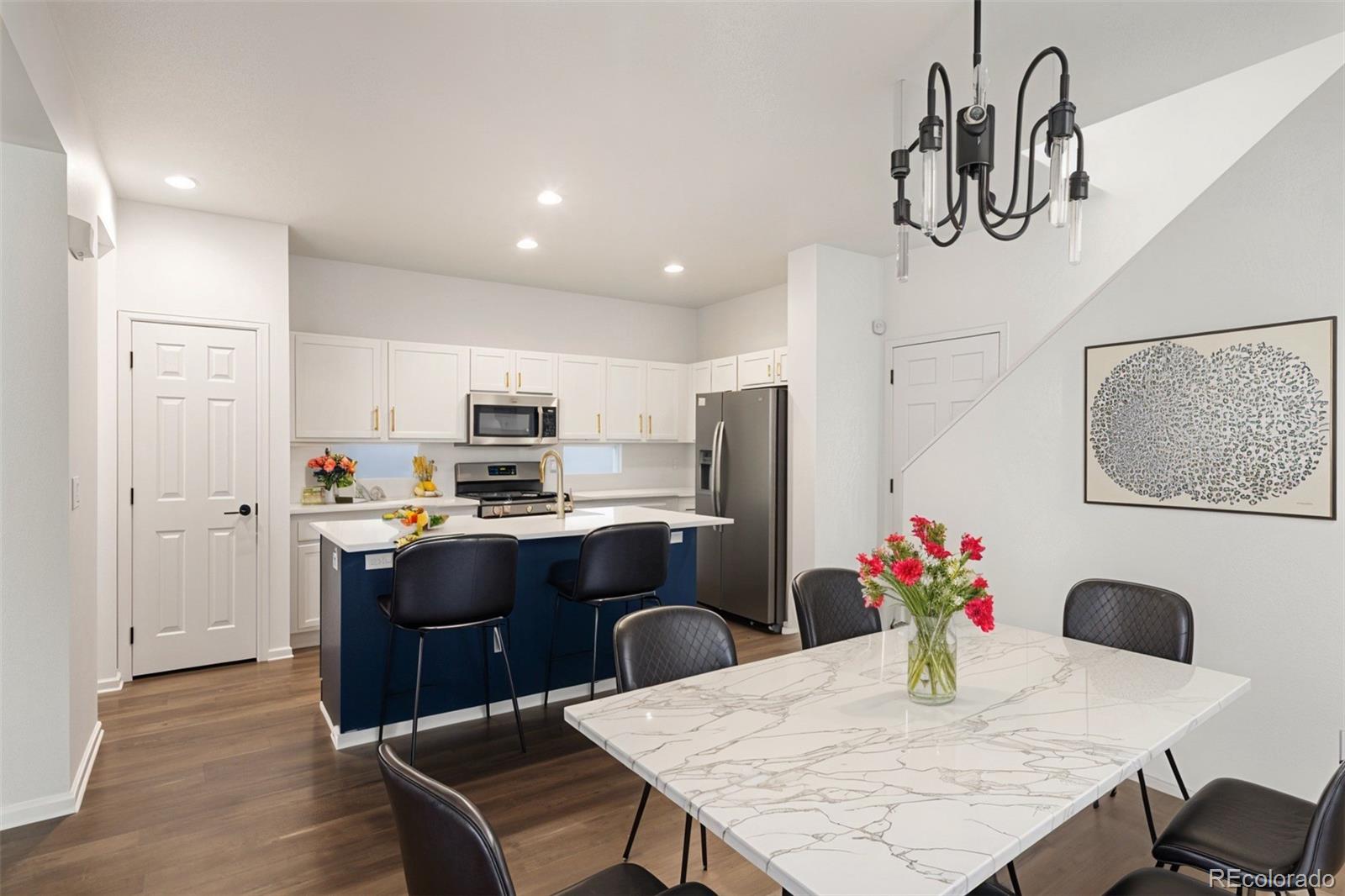 2883 Central Park Boulevard Denver, CO 80238 - Photo 11 of 27 a kitchen with granite countertop kitchen island stainless steel appliances a sink and refrigerator