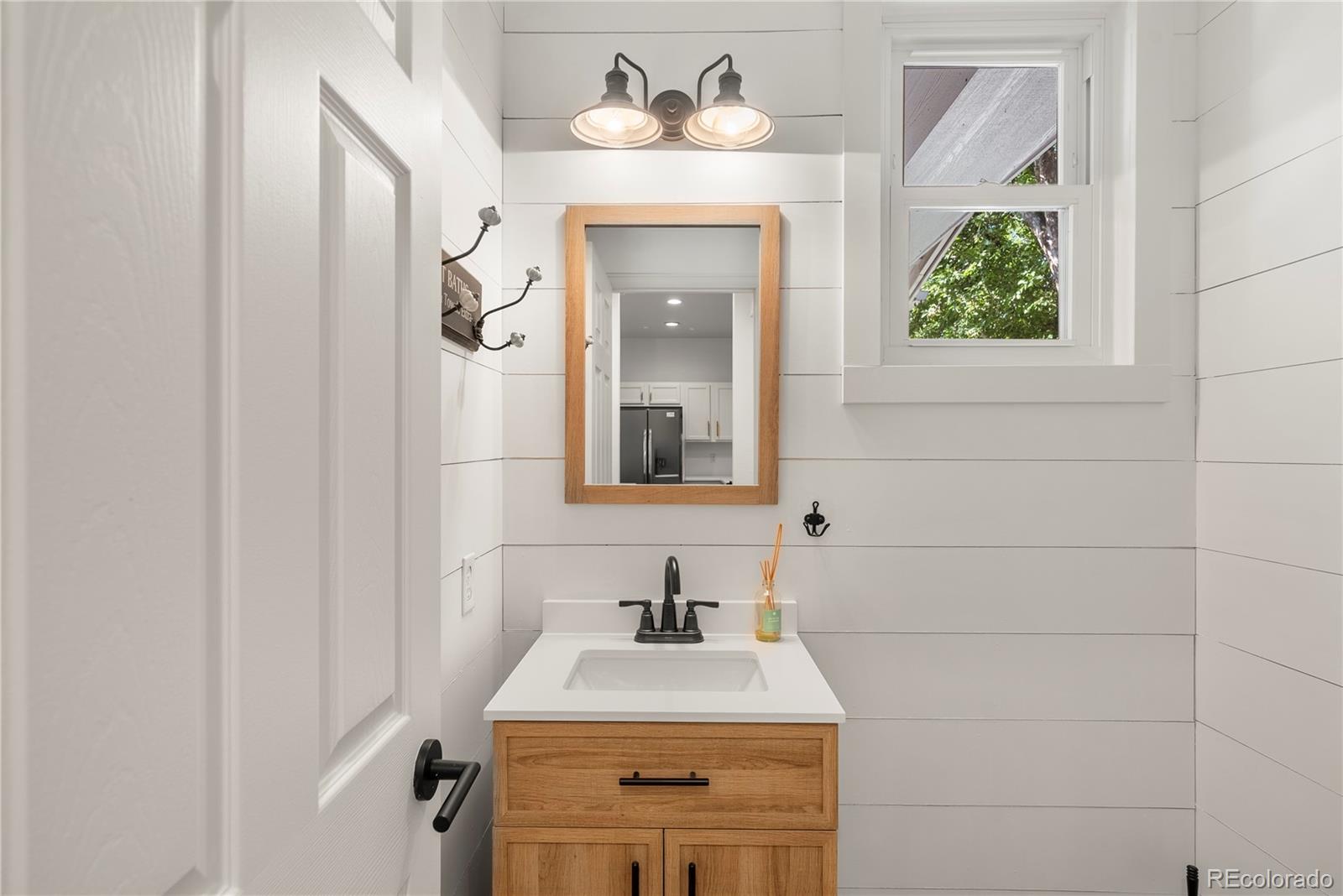 2883 Central Park Boulevard Denver, CO 80238 - Photo 12 of 27 a bathroom with a sink and a mirror