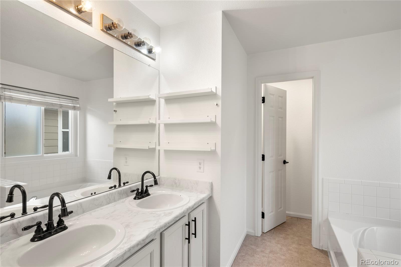 2883 Central Park Boulevard Denver, CO 80238 - Photo 15 of 27 a bathroom with a sink and a mirror