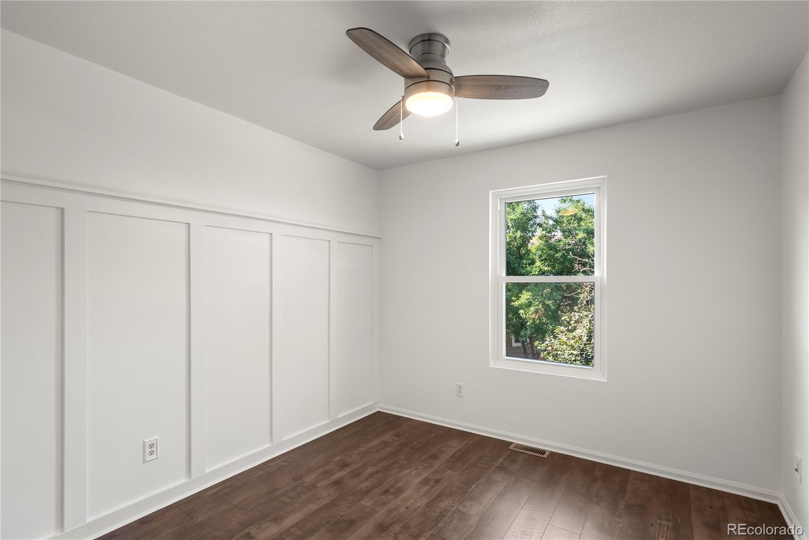 2883 Central Park Boulevard Denver, CO 80238 - Photo 18 of 27 wooden floor in an empty room with a window