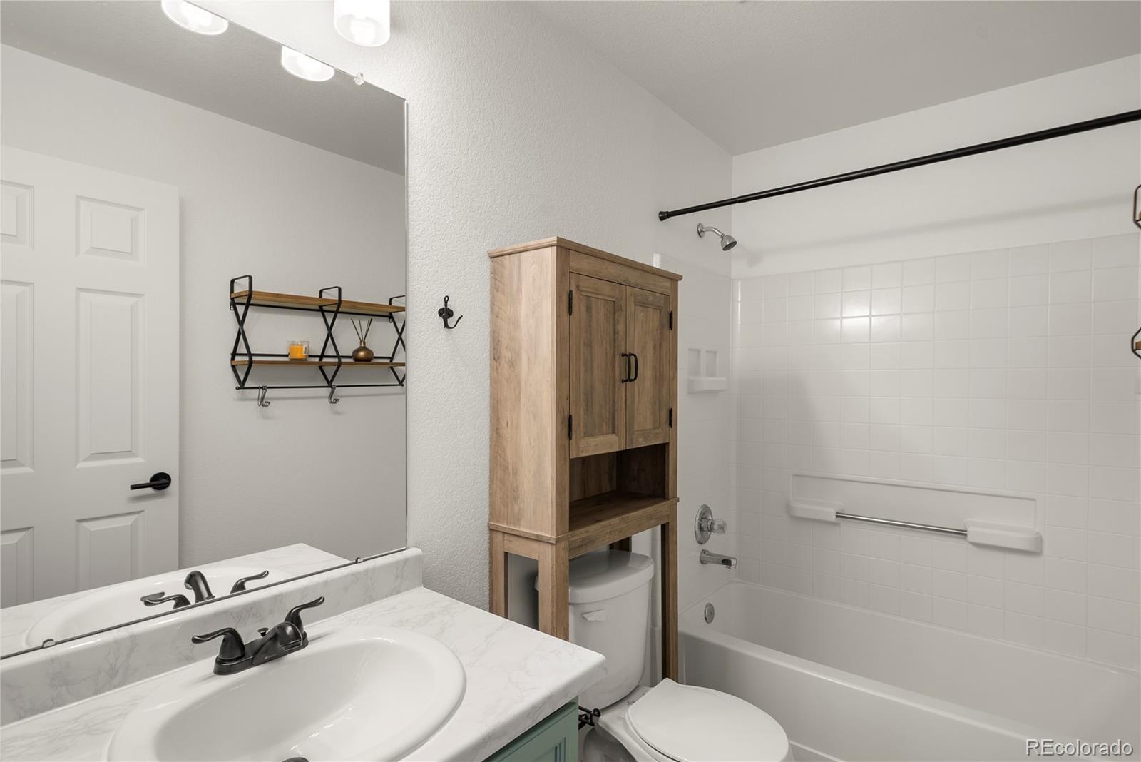 2883 Central Park Boulevard Denver, CO 80238 - Photo 20 of 27 a bathroom with a sink toilet and shower