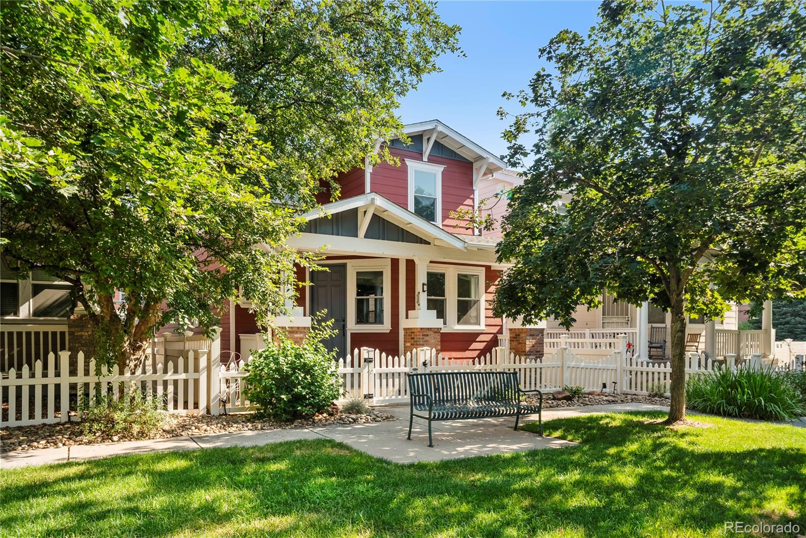 2883 Central Park Boulevard Denver, CO 80238 - Photo 2 of 27 a front view of a house with a yard table and chairs