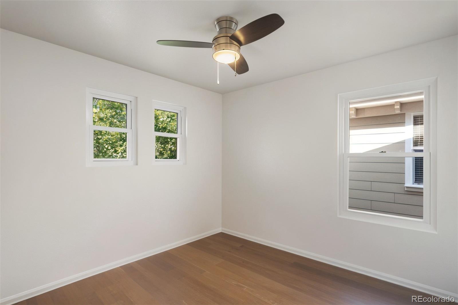 2883 Central Park Boulevard Denver, CO 80238 - Photo 21 of 27 wooden floor in an empty room with a window