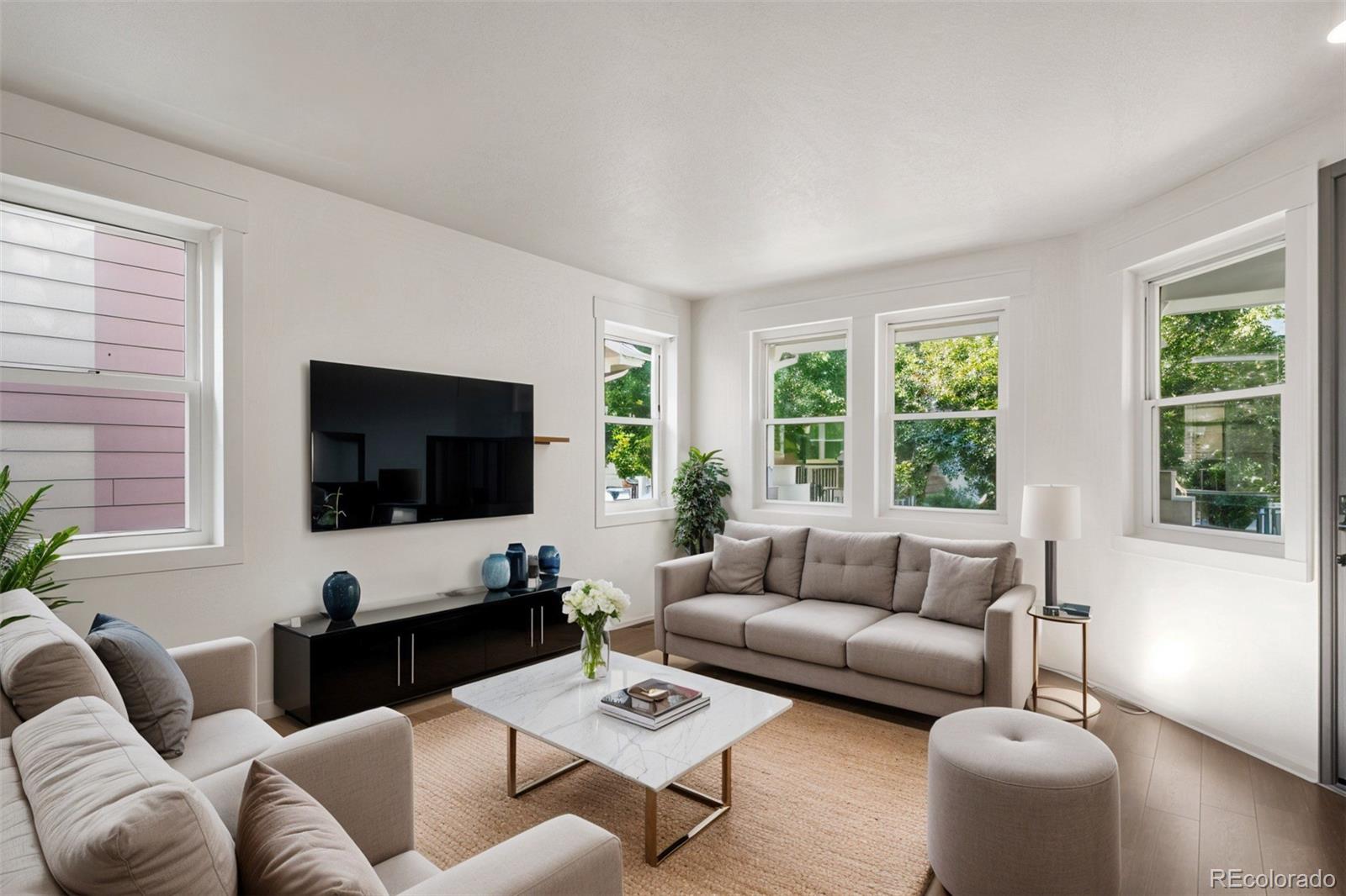 2883 Central Park Boulevard Denver, CO 80238 - Photo 5 of 27 a living room with furniture and a flat screen tv