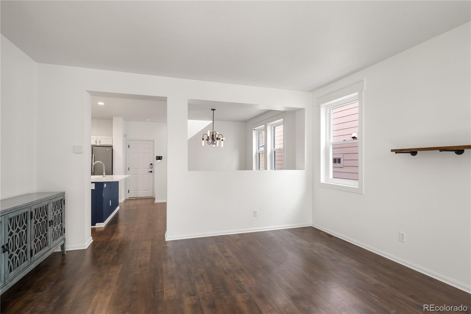 2883 Central Park Boulevard Denver, CO 80238 - Photo 6 of 27 an empty room with wooden floor and windows