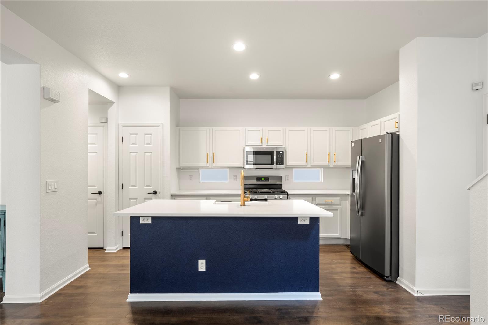 2883 Central Park Boulevard Denver, CO 80238 - Photo 8 of 27 a kitchen with stainless steel appliances a refrigerator sink and microwave
