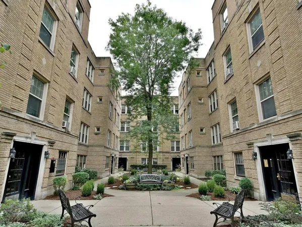 a view of a building with a yard