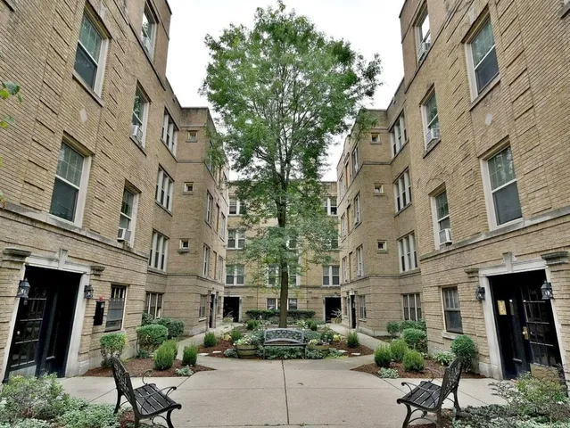 a view of a building with a yard