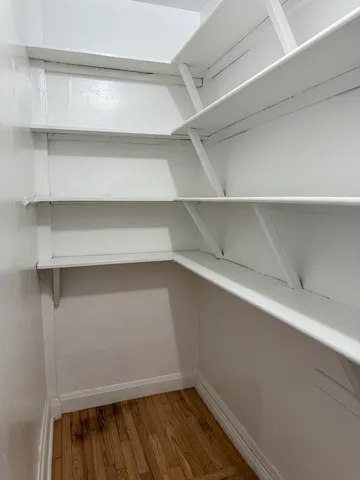a view of walk in closet with empty racks