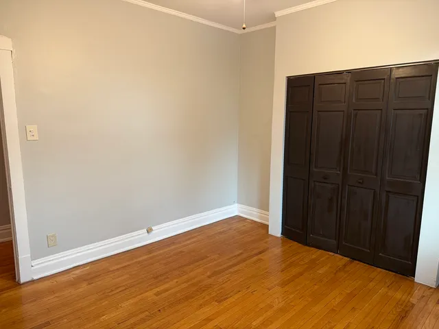 an empty room with wooden floor